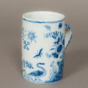 A 19th century blue and white tin glazed tankard Decorated with bird and butterflies amongst