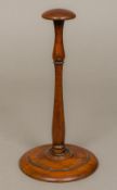 A 19th century turned mahogany wig stand Of typical form. 28 cm high.