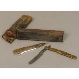 A cased pair of 19th century pressed horn handle cutthroat razors Each decorated with intertwined