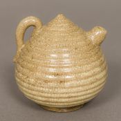 A Chinese "Five Kingdoms" pottery water dropper Of ribbed beehive form. 8.5 cm high.