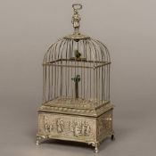 A Continental 925 hallmarked white metal birdcage automaton The singing bird with companion