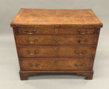 A Georgian and later pollard oak bachelor's chest of drawers With hinged moulded crossbanded top