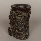 A Chinese Qing Dynasty zitan wood carved brush pot Worked with a sage seated among pine trees in a