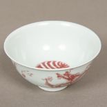 A Chinese porcelain bowl Decorated with dragons chasing flaming pearls. 12.5 cm diameter.