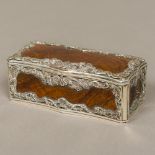 A 19th century unmarked silver mounted olive wood snuff box Of serpentine form, with shell,