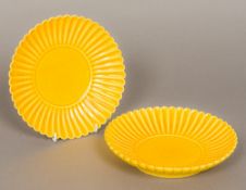 A pair of Chinese porcelain yellow ground plates With lapette moulded borders,