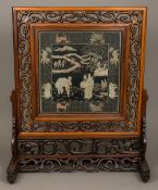 A late 19th/early 20th century Chinese carved hardwood table screen Of large proportions,