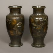 A pair of large Japanese bronze vases Each decorated with a crane, in naturalistic setting. 53.
