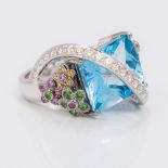 An 18 ct white gold diamond and aquamarine cocktail ring The central domed facet cut aquamarine