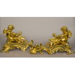 A pair of 18th century ormolu chenets Each of scrolling rococo form,