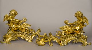 A pair of 18th century ormolu chenets Each of scrolling rococo form,