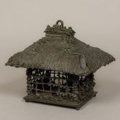 A Meiji period Japanese patinated bronze hanging lantern Formed as a birdcage with thatched roof