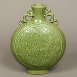 A Chinese pottery moon vase The short flared neck with twin dragon handles and fruiting vines,