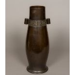 A Chinese bronze arrow vase Of slender baluster form, decorated with a archaistic band. 47 cm high.