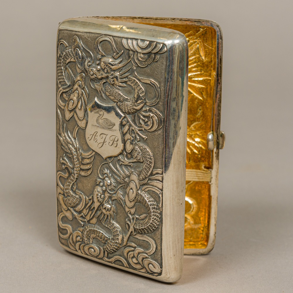 A late 19th/early 20th century Chinese silver cigarette case Embossed to the front with dragons