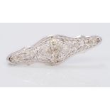 A 14K white gold and diamond brooch Of pierced navette form,