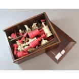 A 19th century bone and stained bone chess set Boxed. The kings each 15 cm high.
