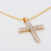 A 9 ct gold diamond set crucifix pendant set with approximately 1.