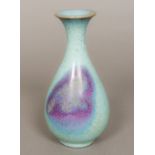 A Chinese Jin Dynasty porcelain Jun Ware vase Of slender baluster form with typical glaze.