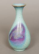 A Chinese Jin Dynasty porcelain Jun Ware vase Of slender baluster form with typical glaze.