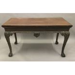 A 19th century mahogany serving table The rectangular top above the frieze with central foliate and