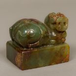A large Chinese russet jade seal Carved with a dog-of-fo and with a carved matrix. 9 cm wide.