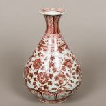 A Chinese porcelain baluster vase Decorated in iron red with lotus strapwork. 31 cm high.