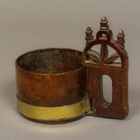 A 19th century Scandinavian treen tankard Of low brass bounded form, with carved and pierced handle.