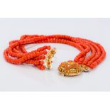 A five strand coral bead necklace Set with cabochon coral mounted pierced gold clasp. 41.