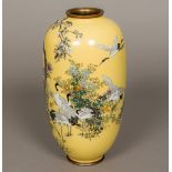 A Japanese cloisonne vase Decorated with cranes amongst floral sprays on a sand coloured ground,