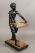 A late 19th century painted carved wooden Blackamoor Modelled as an African boy with glass inset