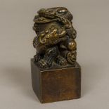 A Chinese cast bronze seal Modelled with two dogs-of-fo and with a calligraphic matrix. 12 cm high.