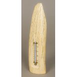 A 19th century desk thermometer Mounted on a polished petrified tusk, possibly mammoth. 31 cm high.