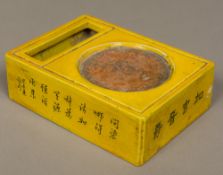 A Chinese porcelain ink stone Of rectangular form, with yellow ground and calligraphic decorations.