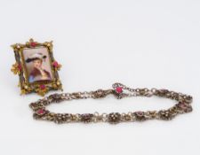 A Victorian gilt metal gem set brooch Centred with a porcelain plaque decorated with a bust of a