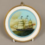 A 19th century reverse painted glass picture of a British three masted sailing ship Of circular