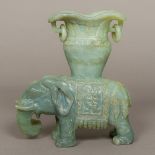 A Chinese carved jade twin handled vase Supported on the figure of an elephant. 22.5 cm high.