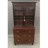 A 19th century mahogany secretaire bookcase The moulded cornice above the twin arched glazed doors