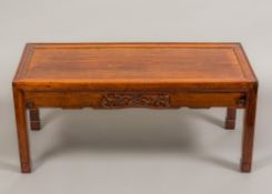 A Chinese huan hua li wood low table The panelled top above a prunus blossom carved long frieze