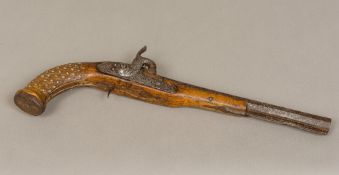 A 19th century Eastern percussion cap pistol The stock with metal stud decoration. 40 cm long.