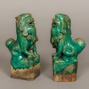 A pair of Chinese porcelain temple lions, Ching Dynasty Typically modelled with green glaze.