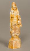 A Chinese fossilized ivory carving of a figure Modelled holding a gourd, standing on a plinth base.