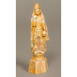 A Chinese fossilized ivory carving of a figure Modelled holding a gourd, standing on a plinth base.