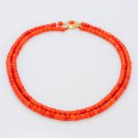 A two strand coral bead necklace Set with a cabochon mounted gold clasp. 49.5 cm long.