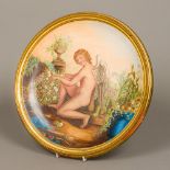 A 19th century Mintons painted porcelain charger Decorated with cupid in a garden,