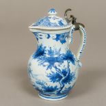 An antique Delft blue and white pottery lidded jug Decorated with a crowned violinist before a
