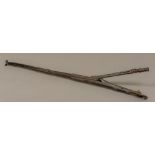 A set of 17th century wrought iron ember tongs Of sprung form with pierced thumbpiece and turned