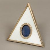 An guilloche enamel decorated silver picture frame Of triangular form with strut support,