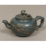 A Chinese Ying Ying pottery teapot Of globular form, with leaf decoration,