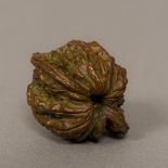 A bronze model of a walnut Naturalistically cast. 4 cm wide.